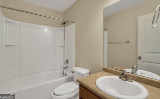 bathroom featuring toilet, washtub / shower combination, and vanity