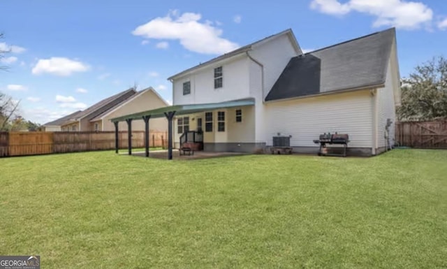 rear view of property with a patio area, a fenced backyard, and a yard