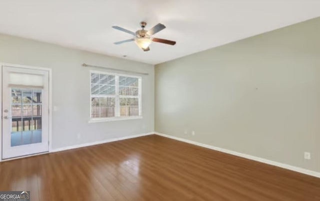 spare room with baseboards and a healthy amount of sunlight