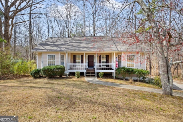 ranch-style house featuring a porch and a front yard