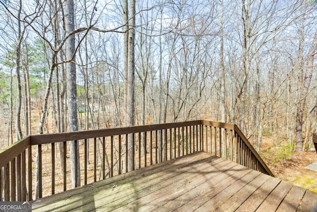 wooden deck featuring a forest view