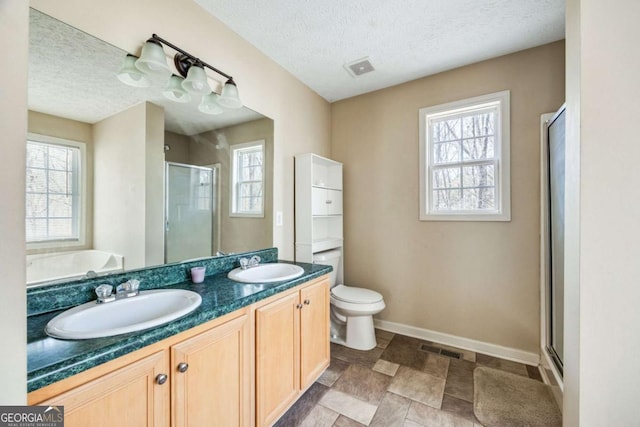 264 Pioneer Trl, Dallas, GA 30132 - bathroom with a shower stall, a textured ceiling, double vanity, healthy amount of natural light, and a garden tub