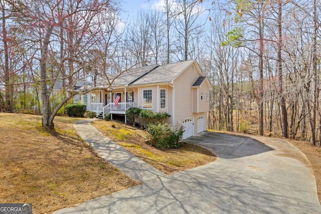 view of front of property featuring an attached garage, covered porch, and aphalt driveway