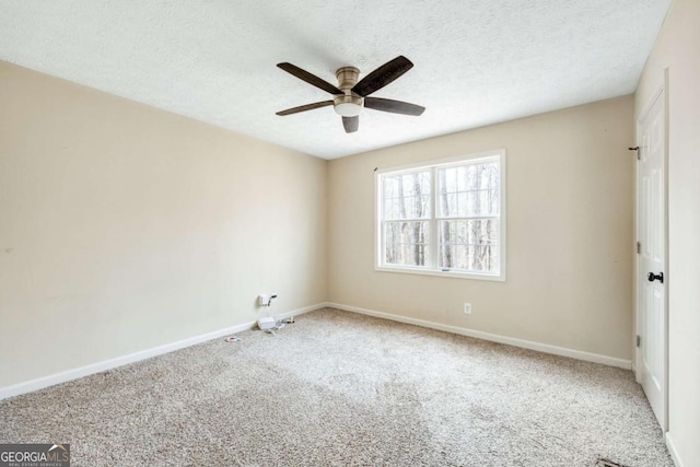 carpeted empty room with a ceiling fan, a textured ceiling, and baseboards