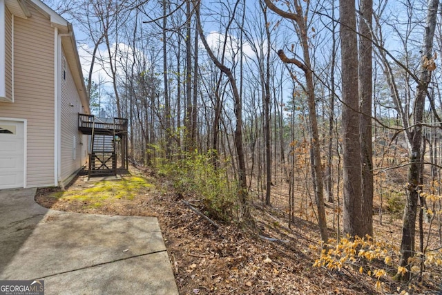264 Pioneer Trl, Dallas, GA 30132 - view of yard featuring stairs, a deck, and a garage
