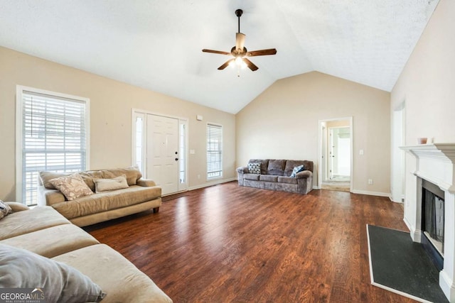 living room featuring a healthy amount of sunlight, wood finished floors, and a glass covered fireplace