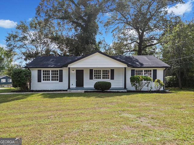 single story home featuring a front yard and brick siding