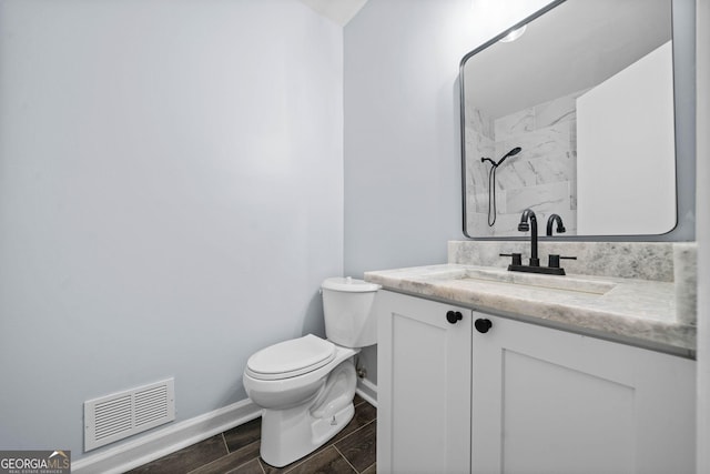 bathroom with toilet, wood finish floors, vanity, visible vents, and walk in shower