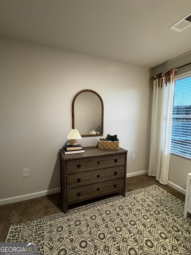 bedroom with carpet, visible vents, and baseboards