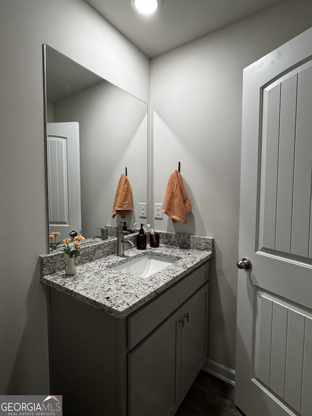 bathroom featuring vanity and baseboards