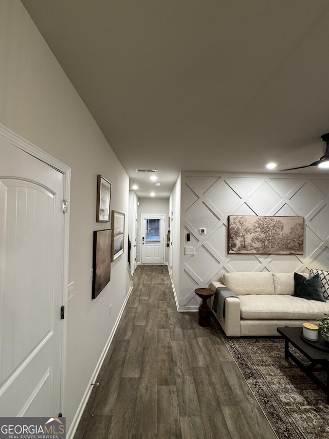 hall with dark wood finished floors and baseboards