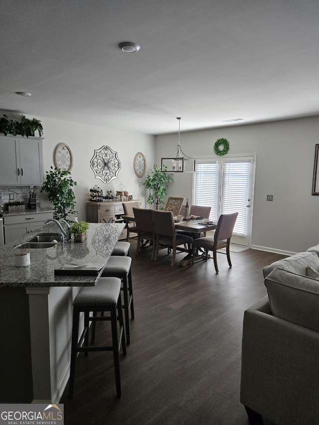 dining space featuring baseboards and dark wood finished floors