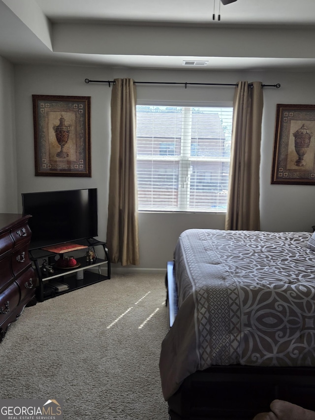 carpeted bedroom with visible vents