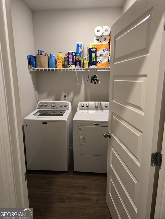 laundry area with dark wood-style floors, laundry area, and washing machine and dryer