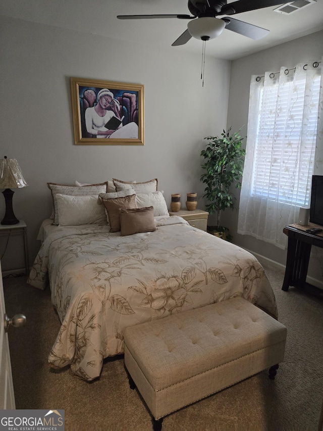 bedroom with carpet flooring, a ceiling fan, and visible vents