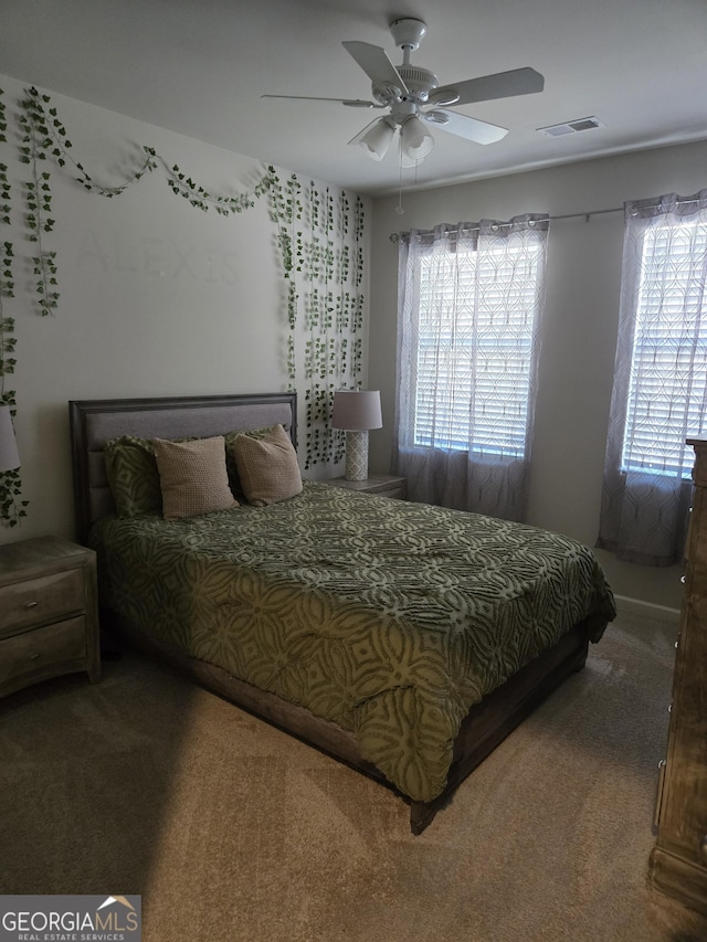 carpeted bedroom featuring visible vents and ceiling fan