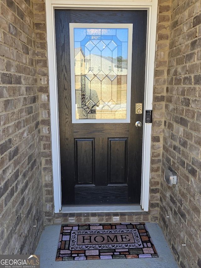 property entrance with brick siding