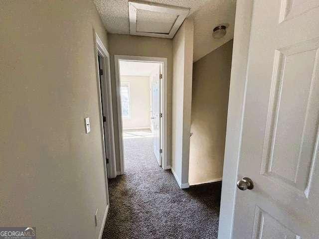 hall featuring carpet floors and baseboards