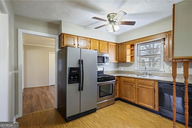 5812 Dogwood Cir, Austell, GA 30168 - kitchen with appliances with stainless steel finishes, light wood-style flooring, brown cabinets, ceiling fan, and open shelves