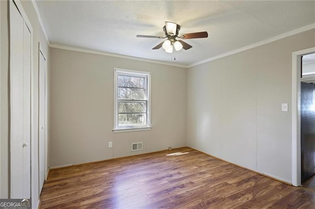 5812 Dogwood Cir, Austell, GA 30168 - unfurnished bedroom featuring wood finished floors, crown molding, and a ceiling fan