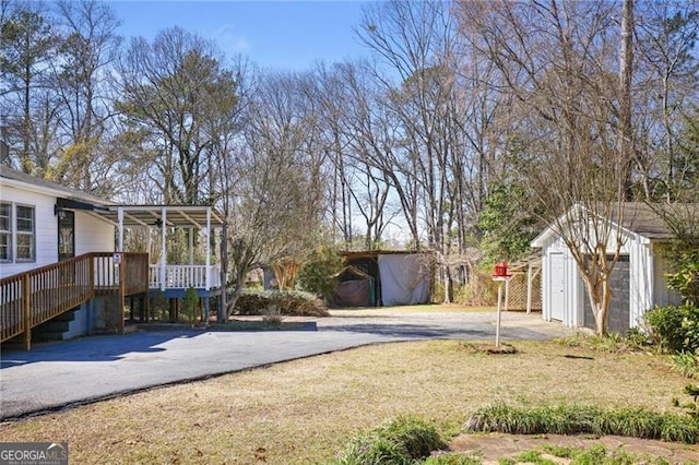 5812 Dogwood Cir, Austell, GA 30168 - view of yard featuring a storage unit, driveway, covered porch, and stairway