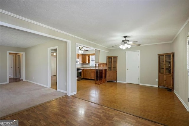 5812 Dogwood Cir, Austell, GA 30168 - unfurnished living room featuring a ceiling fan, wood finished floors, crown molding, and a textured ceiling