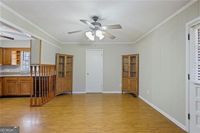 5812 Dogwood Cir, Austell, GA 30168 - unfurnished living room featuring a ceiling fan, light wood finished floors, and ornamental molding