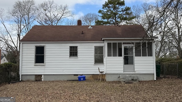 back of property featuring crawl space, a sunroom, a chimney, and fence