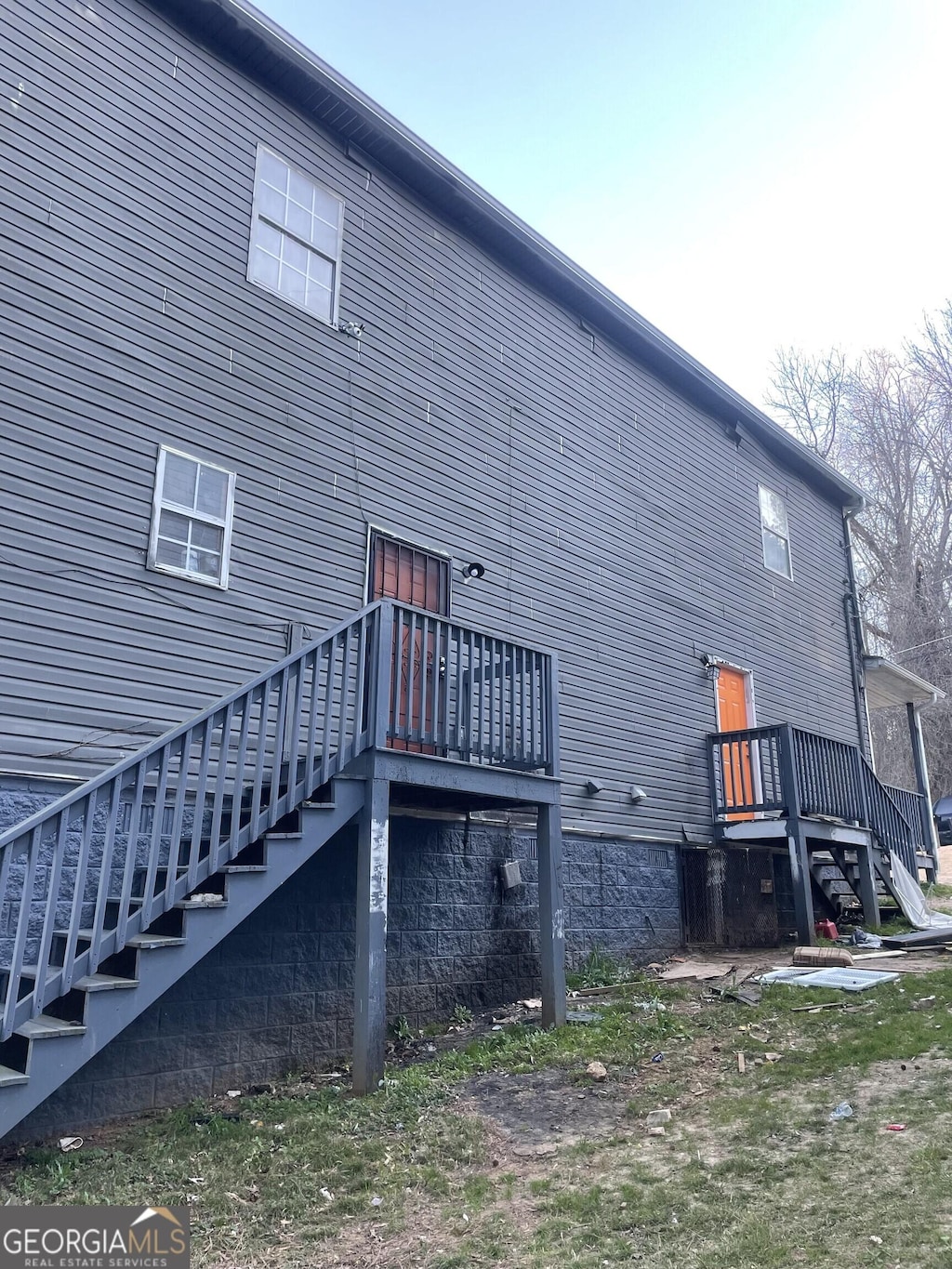 view of side of home featuring stairs