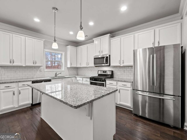 kitchen with stainless steel appliances, white cabinetry, a sink, and dark wood-type flooring