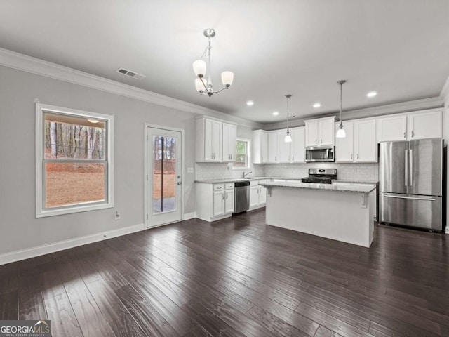 kitchen featuring appliances with stainless steel finishes, backsplash, dark wood finished floors, and visible vents