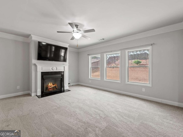 unfurnished living room with carpet flooring, a fireplace with flush hearth, and crown molding