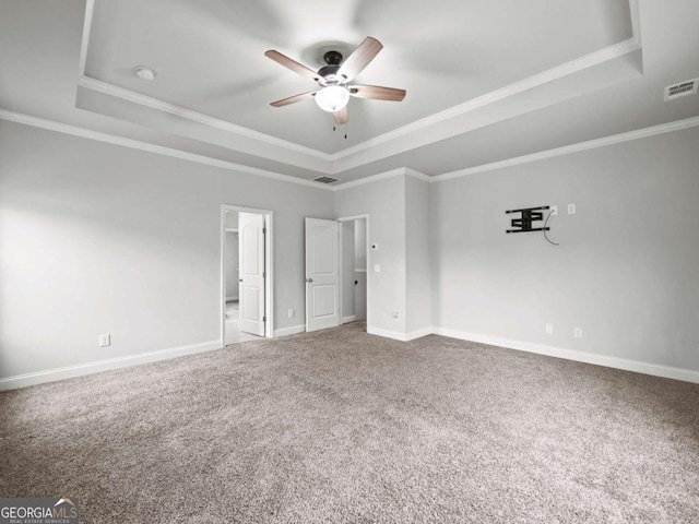 unfurnished bedroom featuring baseboards, visible vents, and a raised ceiling