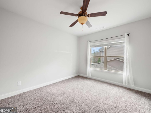 empty room featuring a ceiling fan, baseboards, visible vents, and carpet flooring