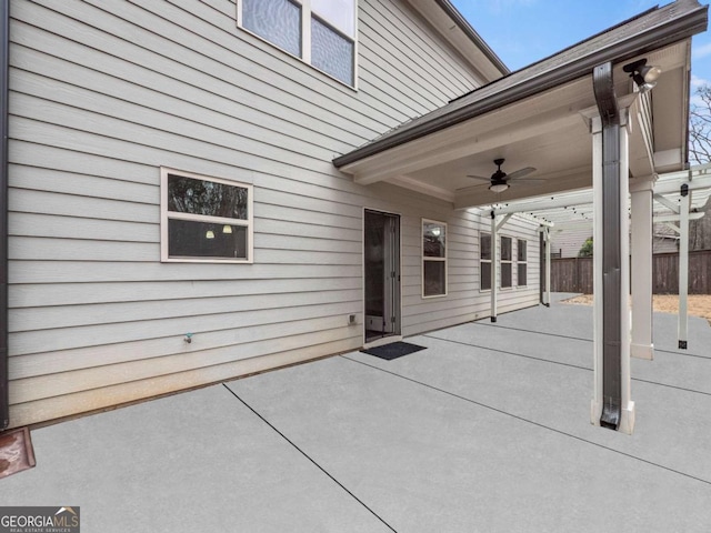 view of patio / terrace with ceiling fan and fence