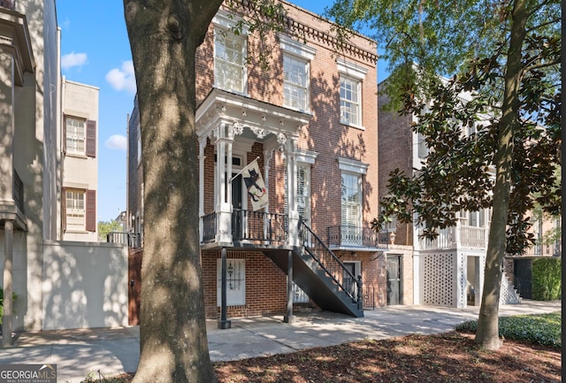 view of front of property with brick siding and stairway