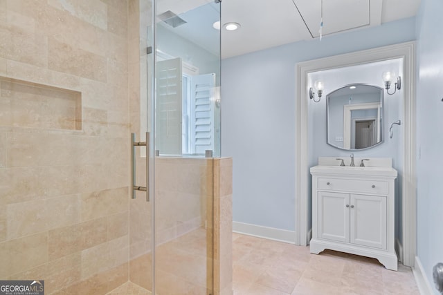 full bath featuring visible vents, a stall shower, vanity, tile patterned flooring, and baseboards