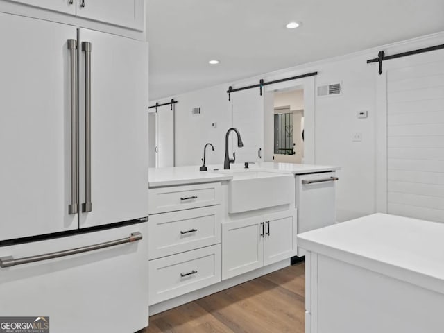 bathroom with recessed lighting, visible vents, wood finished floors, and vanity