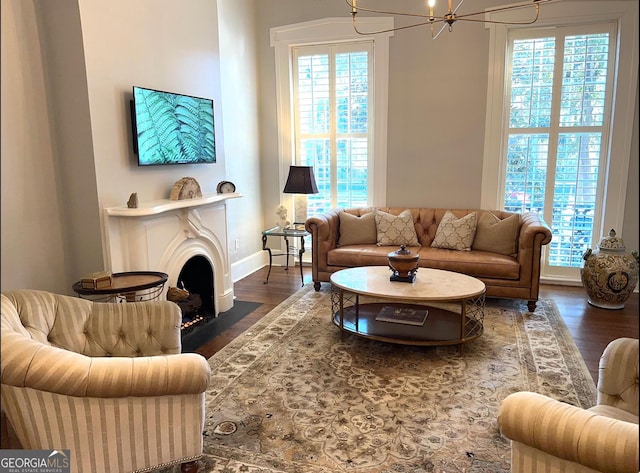 204 E Liberty St, Savannah, GA 31401 - living area with wood finished floors, plenty of natural light, a chandelier, and a fireplace with flush hearth