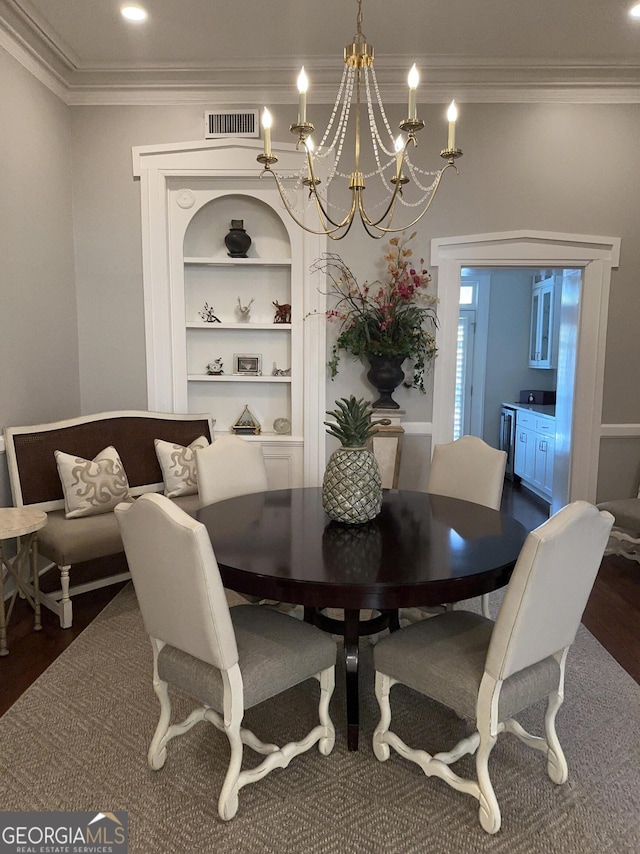 204 E Liberty St, Savannah, GA 31401 - dining area featuring ornamental molding, wood finished floors, a chandelier, and built in shelves