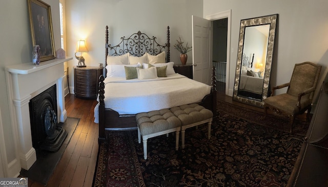 204 E Liberty St, Savannah, GA 31401 - bedroom featuring hardwood / wood-style flooring, baseboards, and a fireplace with raised hearth