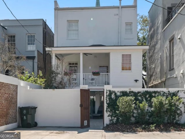 204 E Liberty St, Savannah, GA 31401 - view of front of property with a porch, a fenced front yard, and stucco siding