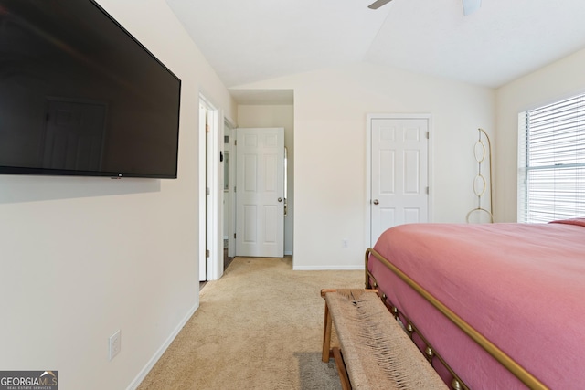 bedroom featuring a ceiling fan, lofted ceiling, light colored carpet, and baseboards