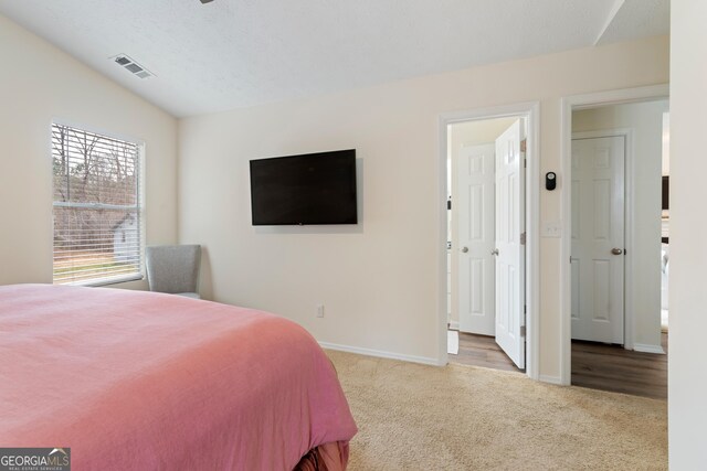 bedroom with baseboards, visible vents, and carpet flooring