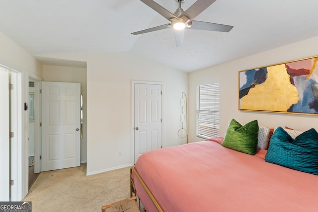 bedroom with vaulted ceiling, ceiling fan, baseboards, and light colored carpet