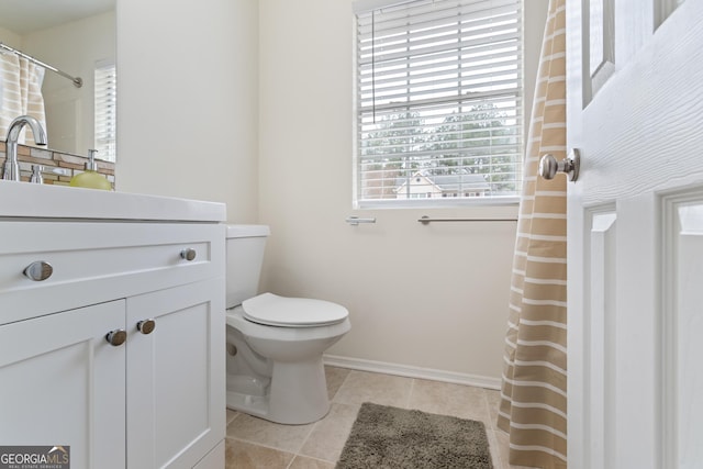 full bath featuring a shower with shower curtain, toilet, vanity, tile patterned flooring, and baseboards