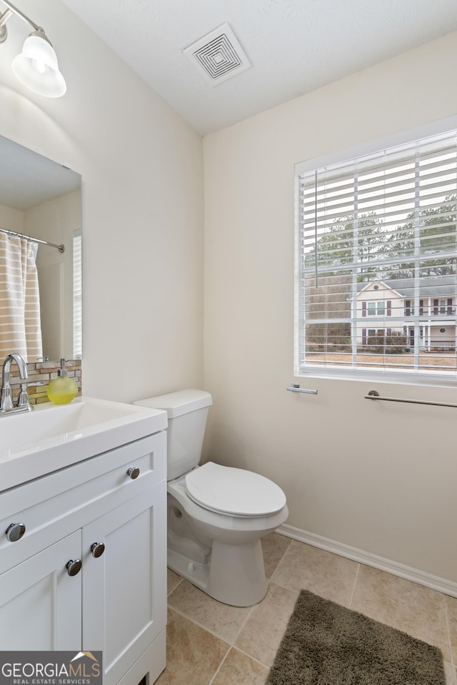 bathroom with toilet, a shower with shower curtain, vanity, visible vents, and tile patterned floors