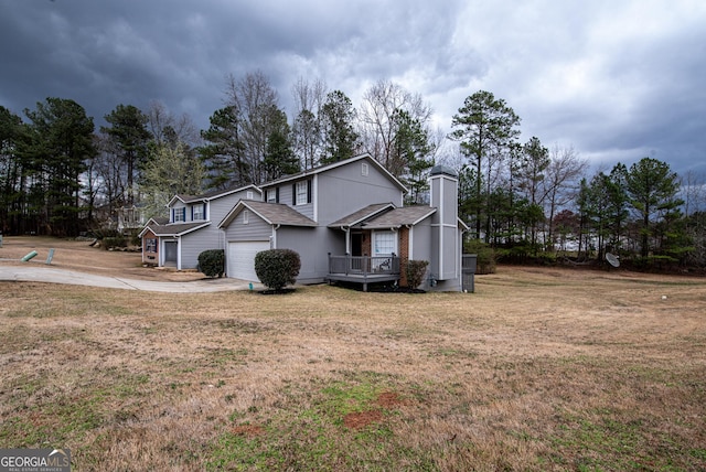 view of side of home with an attached garage, brick siding, driveway, a lawn, and a chimney