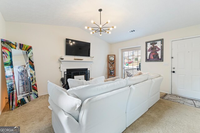 living area featuring visible vents, a glass covered fireplace, an inviting chandelier, vaulted ceiling, and carpet floors