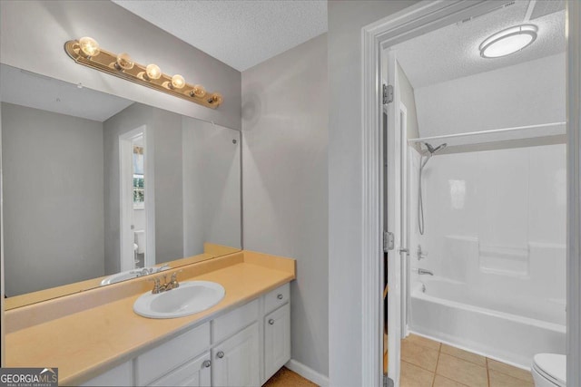 bathroom with tile patterned flooring, a textured ceiling, toilet, and vanity